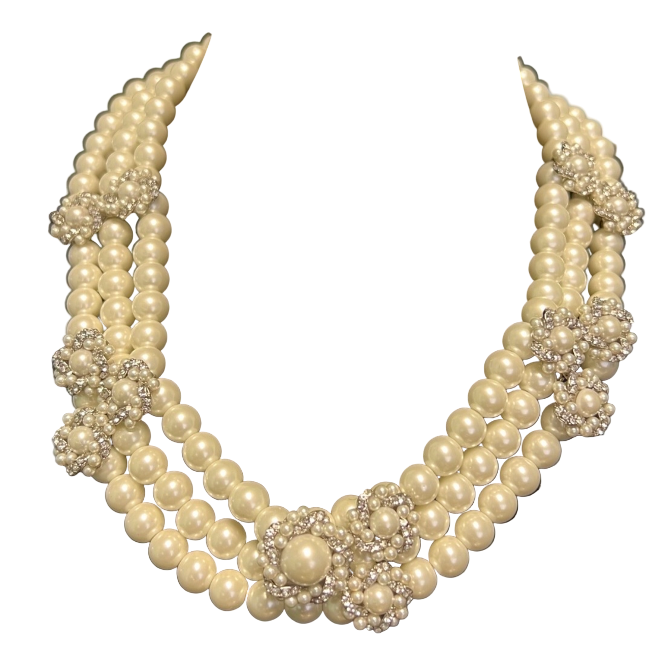 Pearl necklace with silver floral accents on a black velvet stand