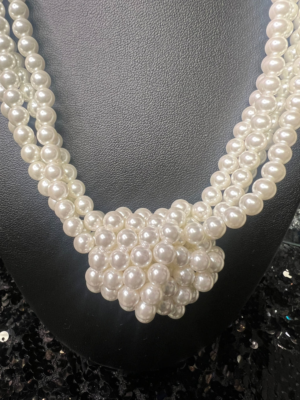 Pearl necklace on a dark textured surface